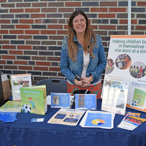 Rachel manning a booth about supporting children in activities.
