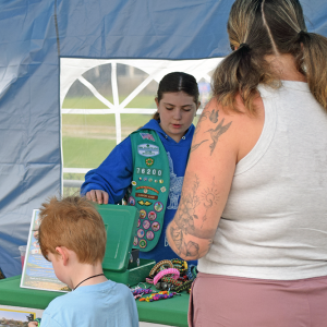 Nora Hecht explains their water safety stations at the Lakeville plant sale. 