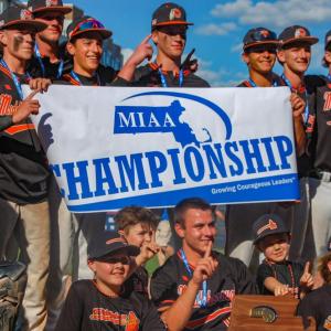 This year's Division 3 champions hold up their trophy and a banner after their win. 