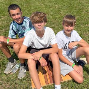 Friends, from left, Andrew Cabral, Nate Wronski and Chase Lynch, all 13, chill out in the sun. 