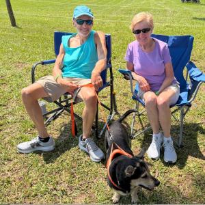 John Raymond, Jeannie Kruja and Toby the dog take in the tunes.