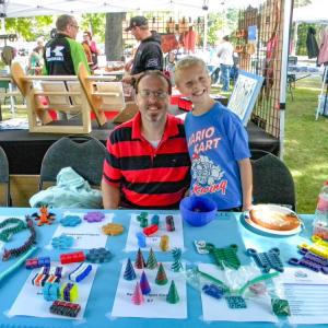 Tristan McPhee, 9, and his father, Gary, at the T's 3D booth. Photo by Christian Uva