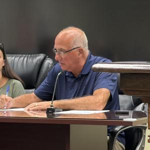 Robert Nunes signs his contract at the Sept. 14 Middleboro Select Board meeting. Photo by Christian Uva