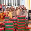 Volunteers stand with the gift boxes they packed at Central Congressional Church. Photo source: Central Congressional Church