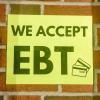 A sign for a store accepting EBT, also known as SNAP benefits. 