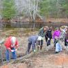 All of the volunteers work together to weave the whips onto the poles. Photos by Kat Sheridan
