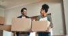 A couple moving into a house with boxes. 